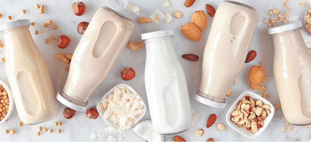 Almond Cow — Plant-Based Milk Bottles Flat Lay